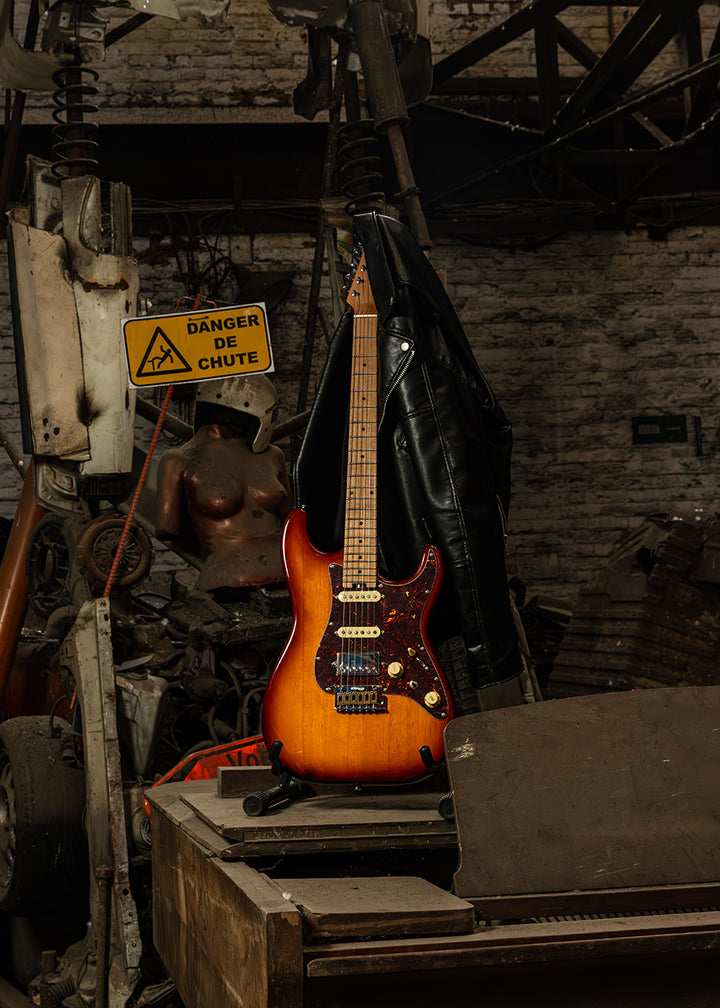 Crafter SVVSM TS guitar resting upright on a rusted piano