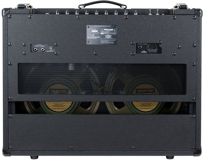 Close-up of dual Celestion G12M Greenback speakers inside the Vox AC15C2.

