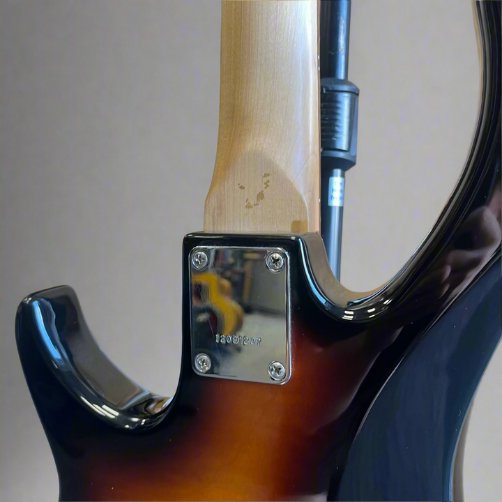 Angle view of Peavey Milestone BXP bass showing Vintage Burst finish

