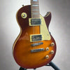 Close-up of humbuckers and control knobs on pre-owned Les Paul-style guitar

