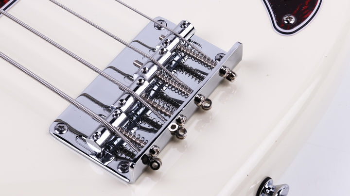 Close-up of the Gould P Style Bass Guitar in Cream, highlighting the chrome hardware and pickup.