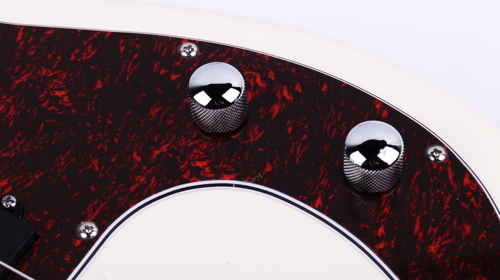 Close-up of the volume and tone control knobs on the Gould P Style Bass Guitar in Cream.