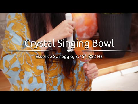  Person playing the 3.75" Essence Solfeggio Crystal Singing Bowl, with sound waves emanating from the bowl.