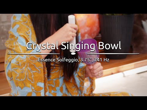 Person playing the 3.75" Essence Solfeggio Crystal Singing Bowl, with sound waves emanating from the bowl.