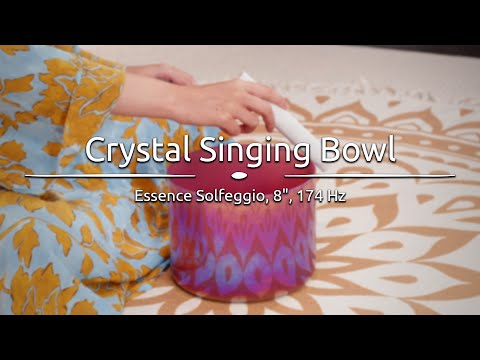 Person gently playing the 8" Essence Solfeggio Crystal Singing Bowl, with sound waves emanating from the bowl.